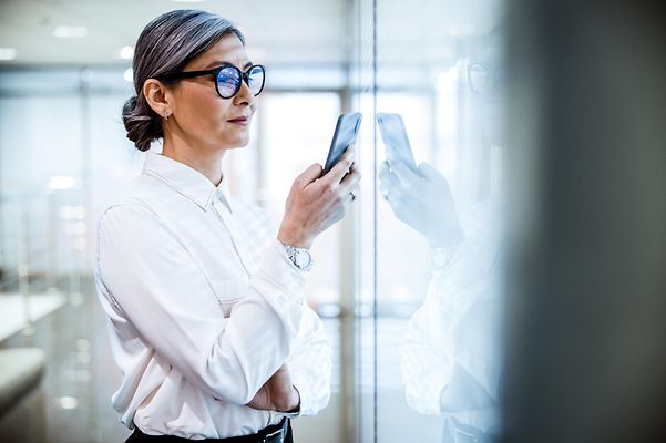 Eine Frau hält ein Smartphone in der Hand