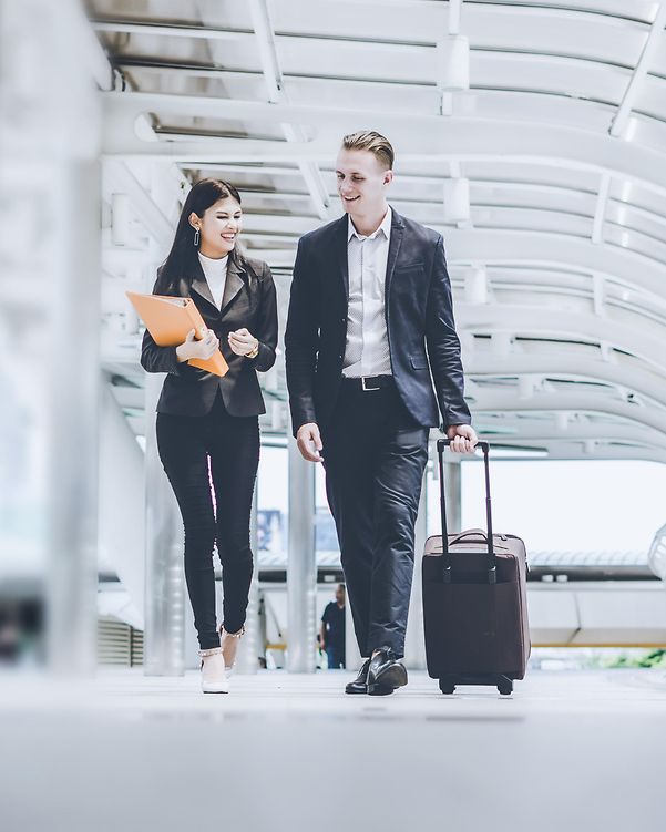 A man and a woman are at the station.