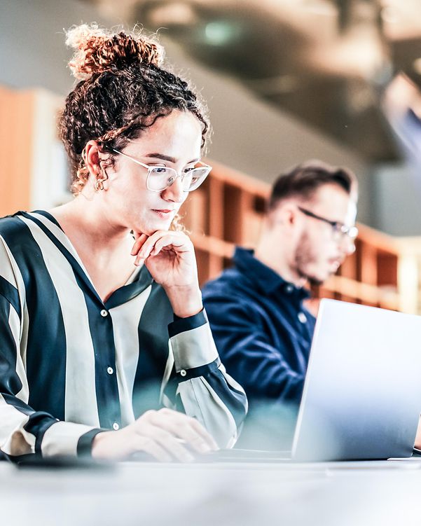 Woman working in a library while travelling