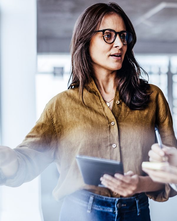 Businesswomen discuss their ideas with sticky notes