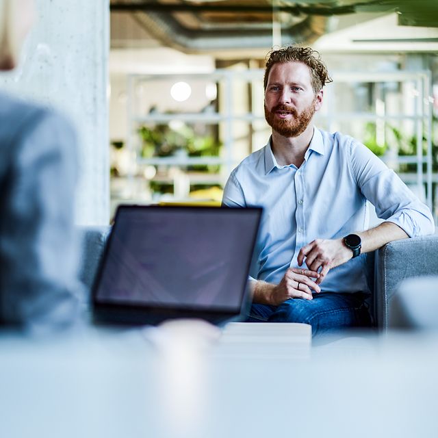 Businessman talking to a colleague in the office