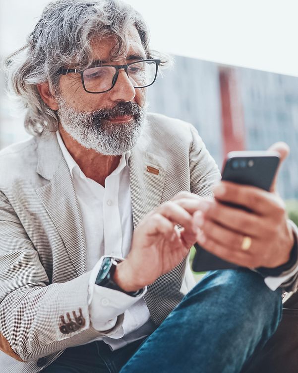 A man types on his smartphone.