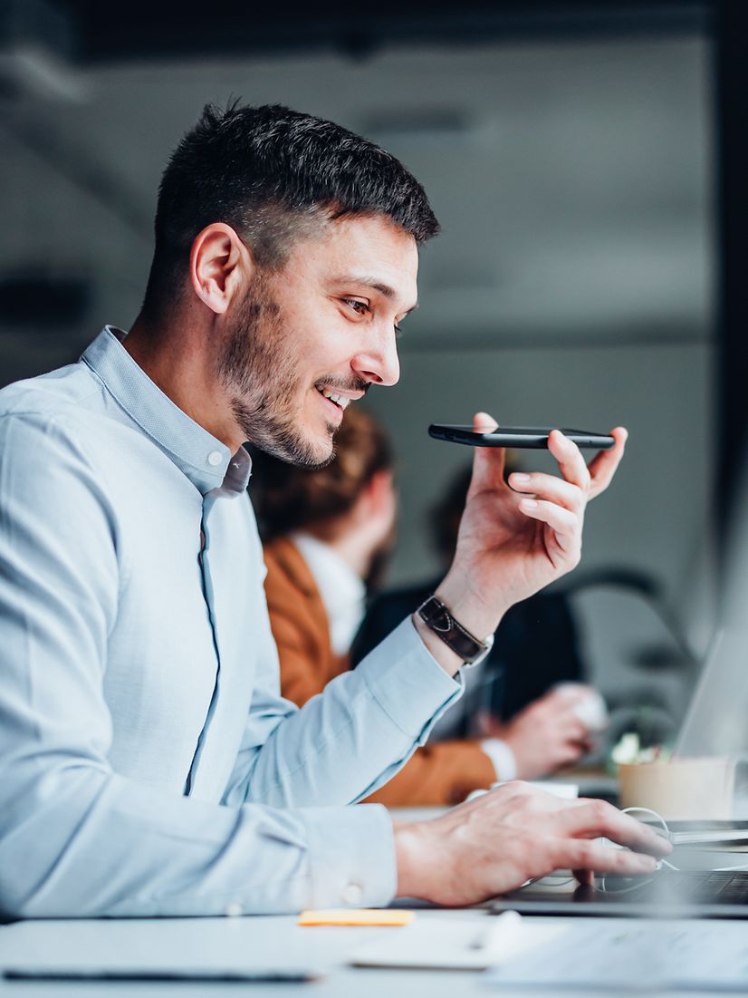 A young man is talking on his smartphone.