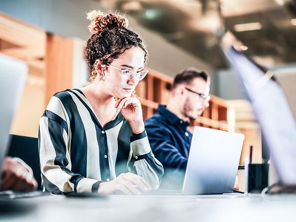 Woman working in a library while travelling