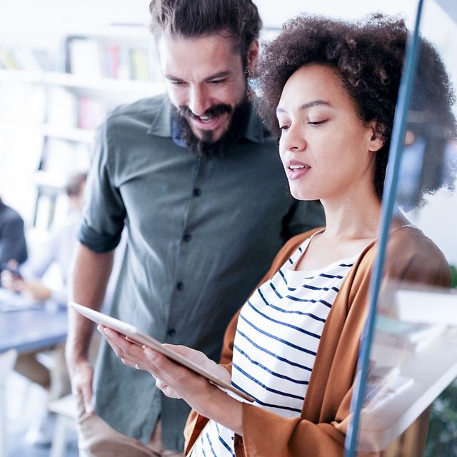Two people looking at a tablet together