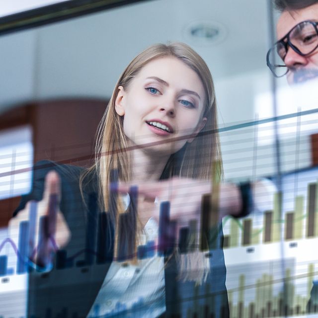 Two businessmen analysing data in front of a futuristic display