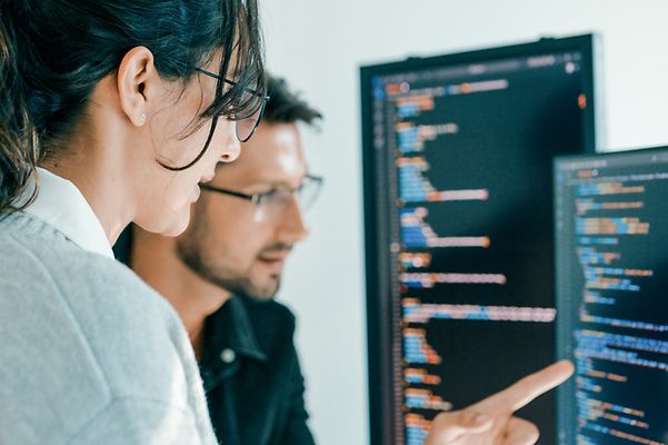 Colleagues look at data on the screen