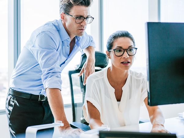 Two people looking at a computer screen