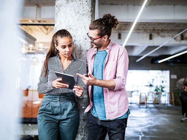 A woman and a man exchange ideas about productive processes.