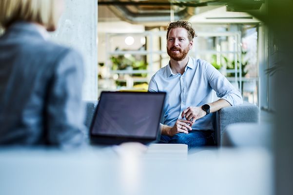 Businessman talking to a colleague in the office