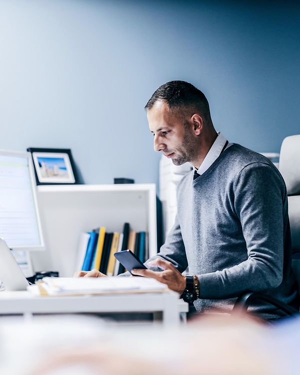 Man at desk confirms a transaction with DocuSign.