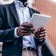 Man in business attire collects data with DocuSign on his tablet