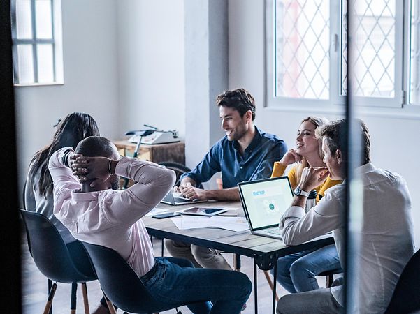 Colleagues at a conference table use XPhone Connect