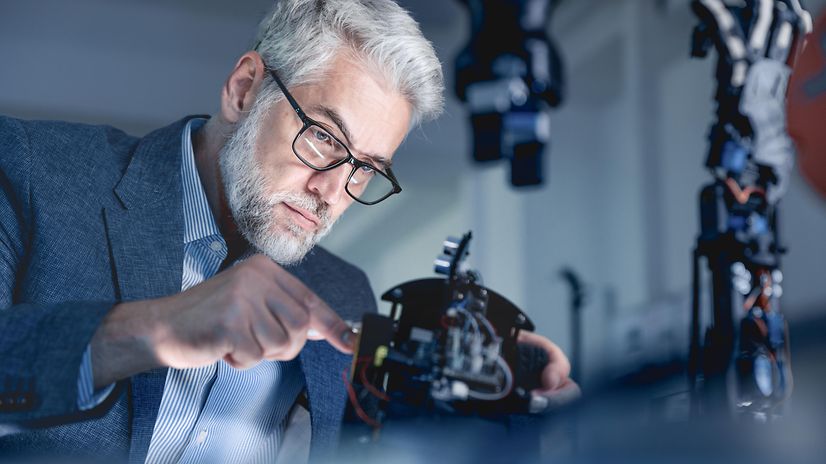 Businessman repairs machine. Image symbolises how Agentforce can optimise business processes.