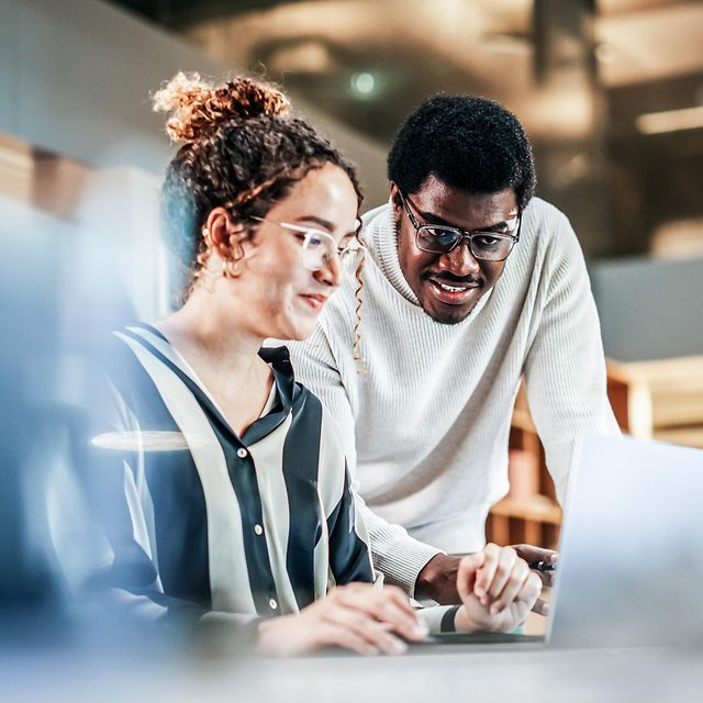Colleagues looking at a monitor together