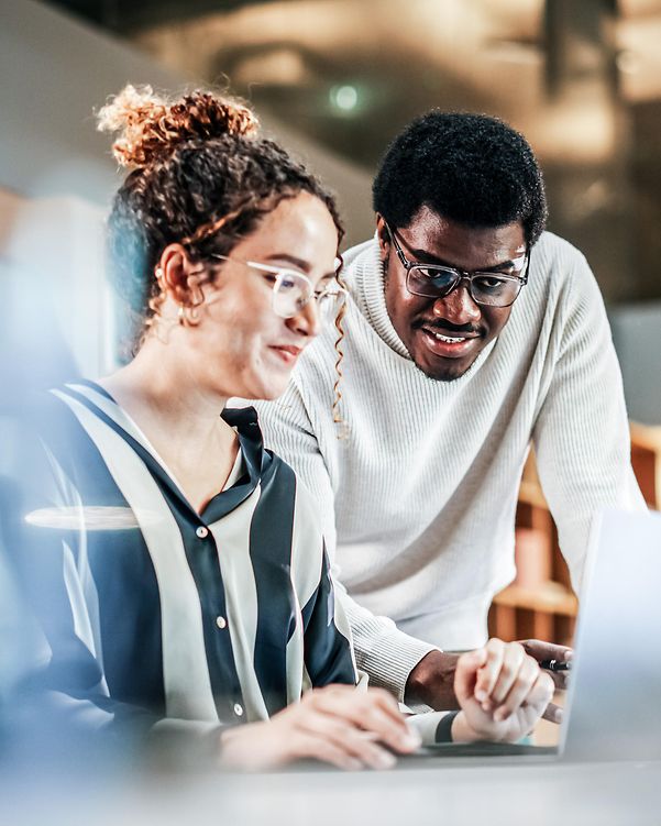 Colleagues looking at a monitor together