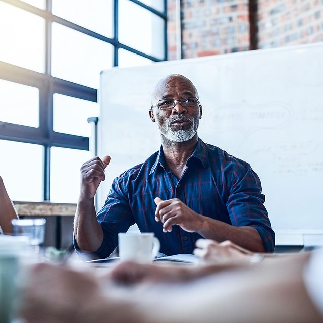 A team consisting of one man and two women is holding a meeting.