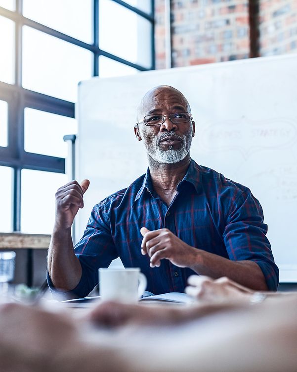 A team consisting of one man and two women is holding a meeting.