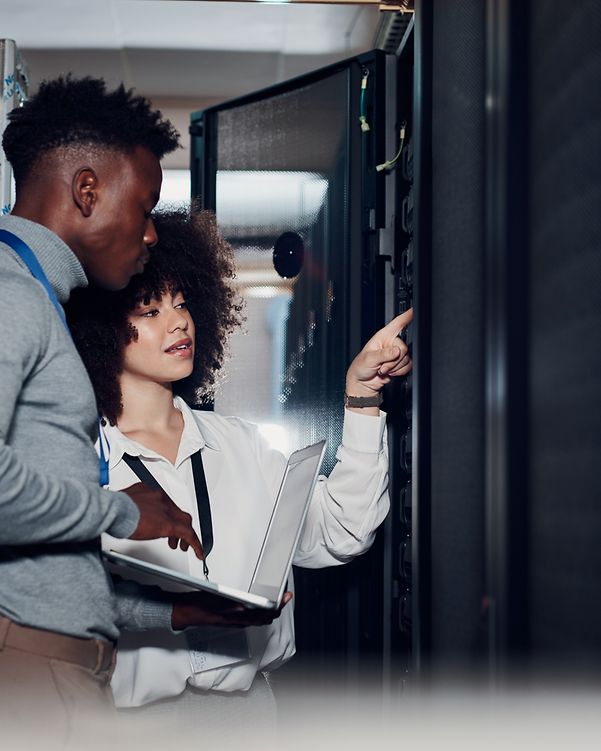 Two people inspect a Telekom server cabinet.