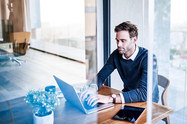 A man is looking at a screen.