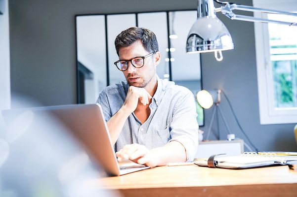 A man looks at a screen.
