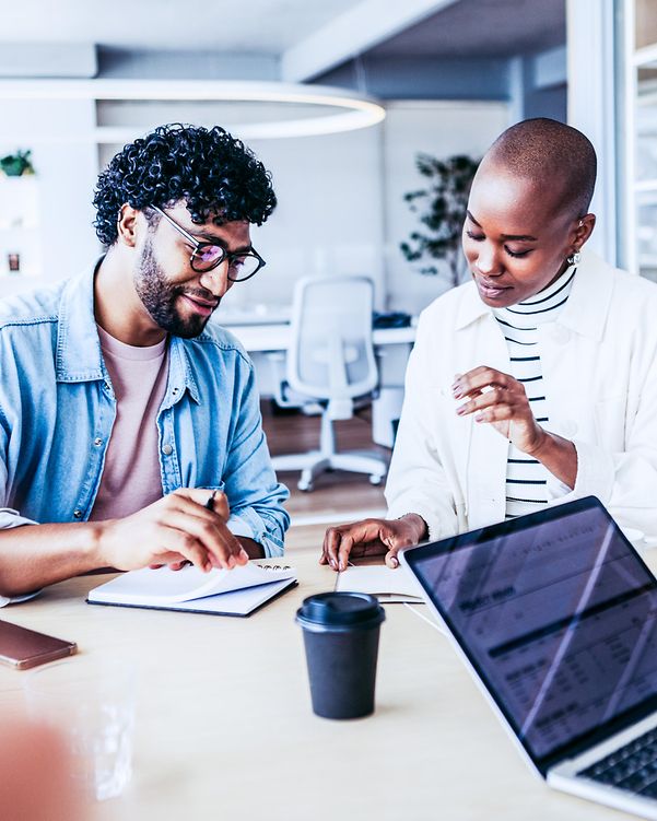 Woman and man in office environment check cloud providers for trustworthiness