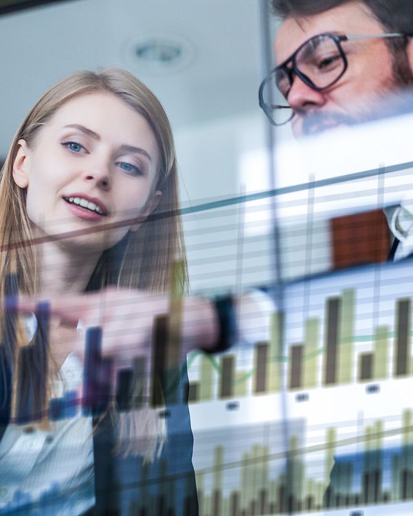 Two businessmen analysing data in front of a futuristic display