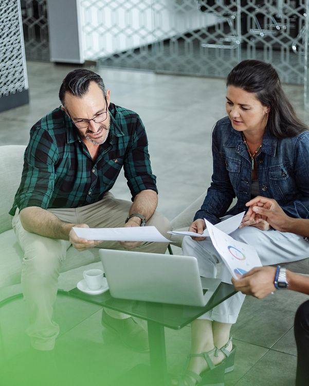 A woman and two men in an office environment discuss decision-making factors for cloud providers.