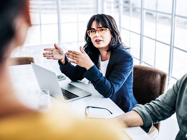 Woman talking to colleagues