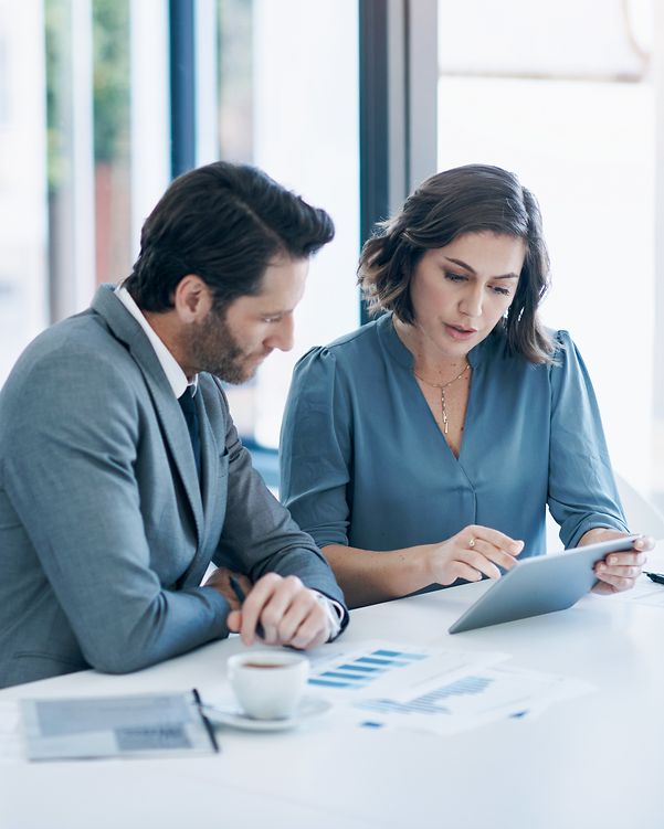 Two businessmen analyse data.