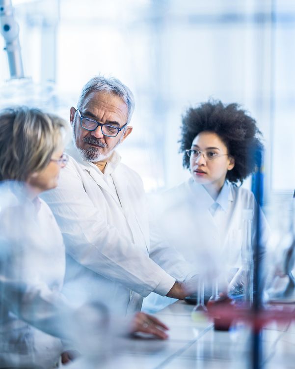 Group of scientists communicating while working together in the laboratory.