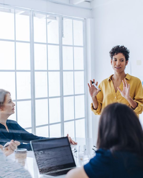 Female project manager at a meeting with her team in an office on the topic of Magenta Security Assessments & Audits