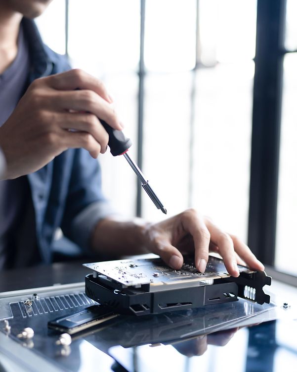 A man is tinkering with a computer component.