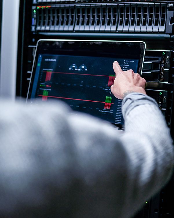 View over the shoulder of a man performing an analysis on a server.
