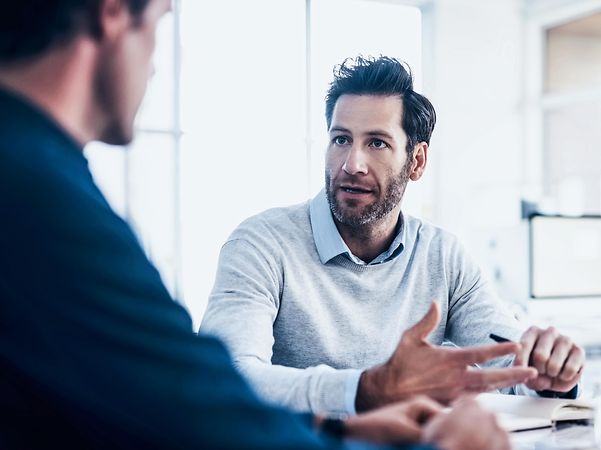Two men are talking about managing eSim profiles.