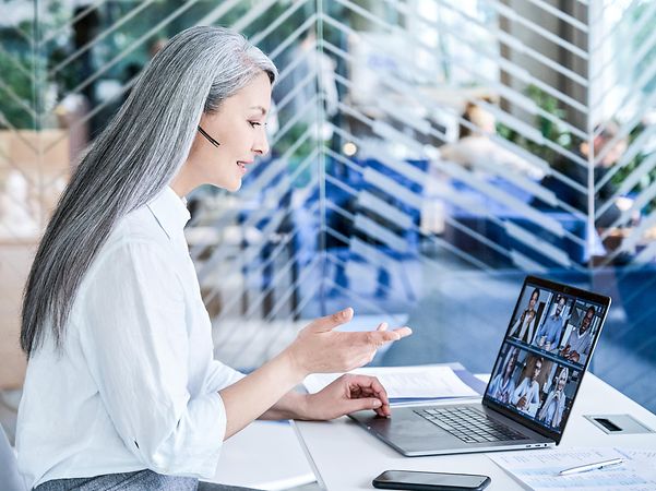 IT expert wearing a headset in a modern office explains Jamf Pro for Apple device management.