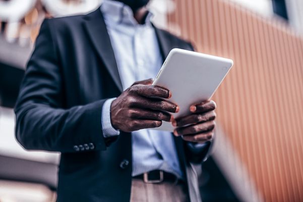Man reading on tablet about mobile security with VPN.