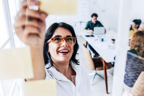 A woman plans to strengthen her brand with her team.