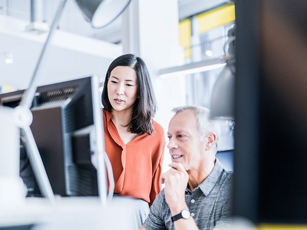 Mann und Frau prüfen den aktuellen Betriebsstatus des BusinessMail X.400 Systems. 