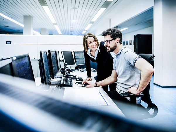 Mann und Frau im Büro unterhalten sich über Beschreibungen und zusätzliche Dokumente zu WebConfig.