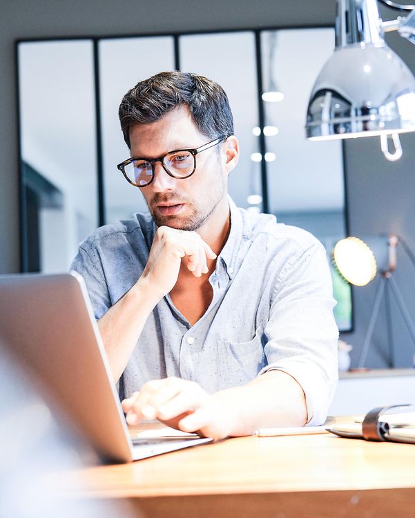 A man looks at his laptop.