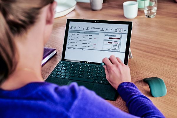 A woman is working on her laptop.
