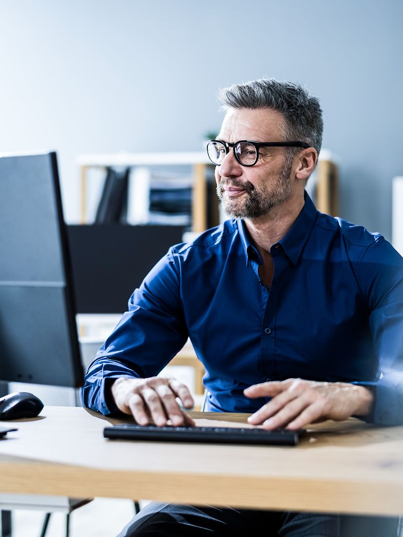 Businessman in office working on computer and using interactive voice response business