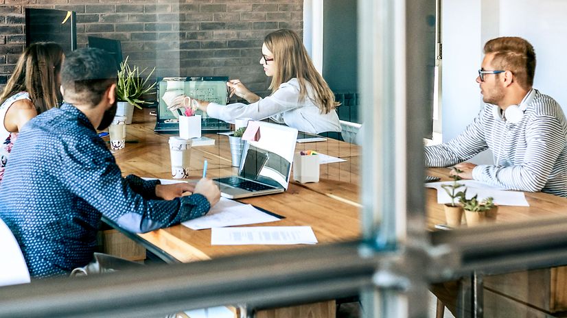 A team in a glass-walled meeting room discusses Telekom's customer contact solutions.