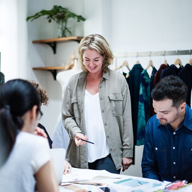 Business Analytics A team stands together in a clothing production facility