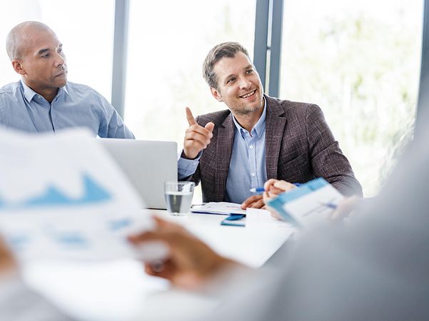 Businessman signing a document with Magenta Security Sign