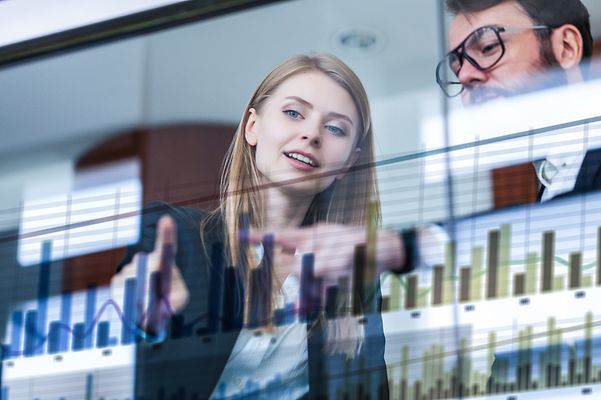 Two businessmen analysing data in front of a futuristic display