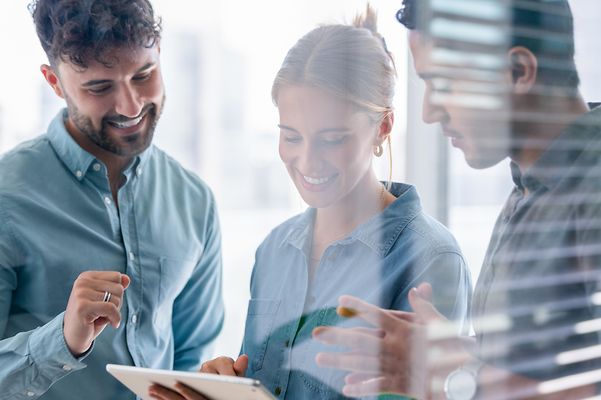 Business team looking at a digital tablet.