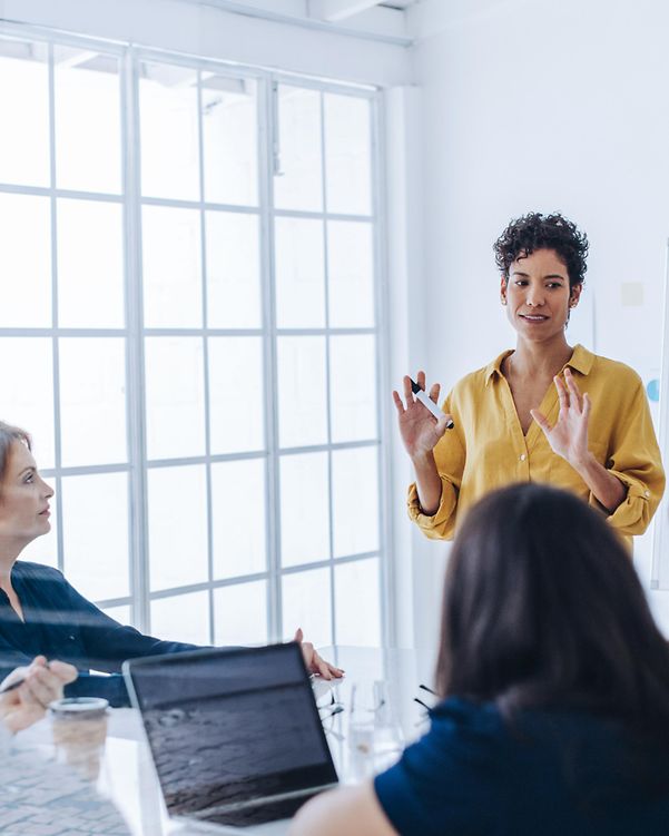 Female project manager in a meeting with her team in an office