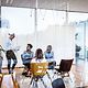 Four people in a meeting room.